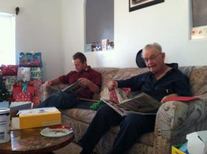 My husband and his father reading their Christmas gifts from my Mother-in-law